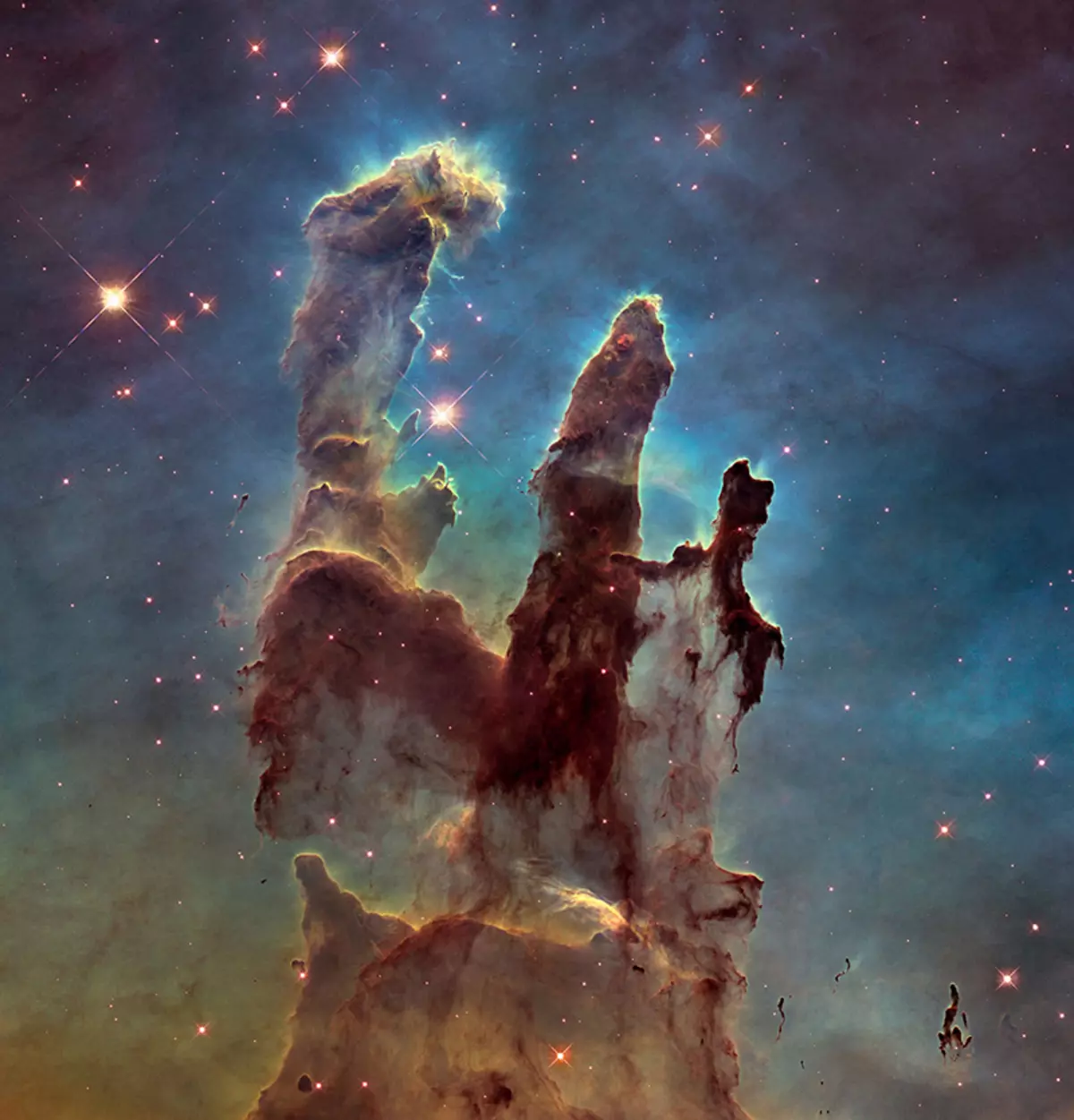 The NASA / ESA Hubble Space Telescope has revisited one of its most iconic and popular images: the Eagle Nebula's Pillars of Creation. This image shows the pillars as seen in visible light, capturing the multi-coloured glow of gas clouds, wispy tendrils of dark cosmic dust, and the rust-coloured elephants 'trunks of the nebula's famous pillars. The dust and gas in the pillars is seared by the intense radiation from young stars and eroded by strong winds from massive nearby stars. With these new images comes better contrast and a clearer view for astronomers to study how the structure of the pillars is changing over time.